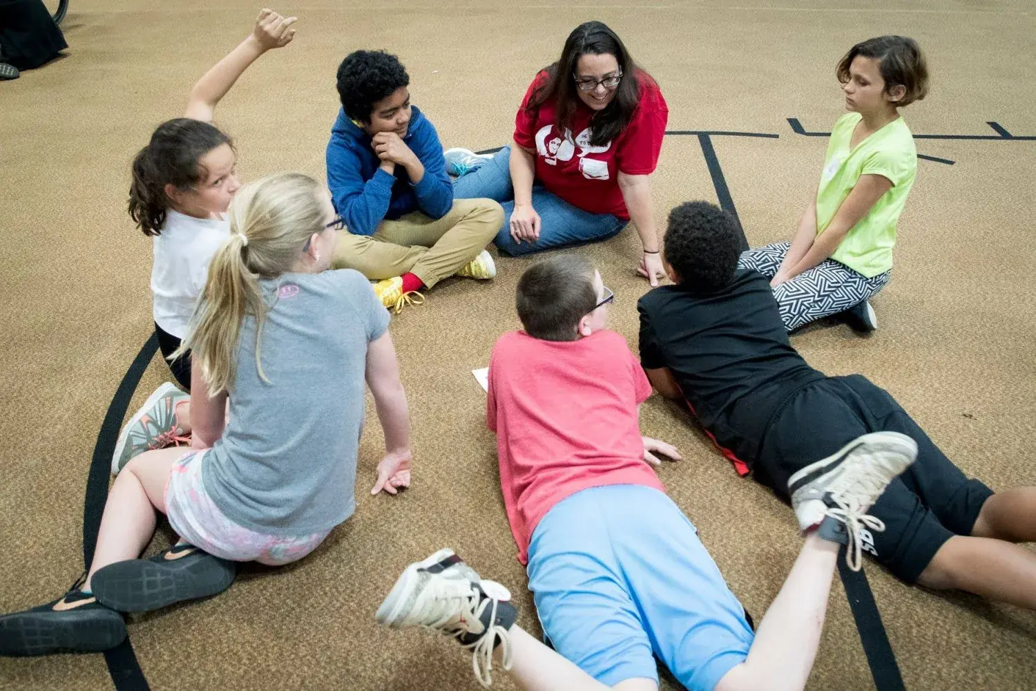 Children seated on the floor during a museum program.