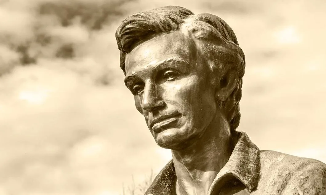 A bronze statue of Abraham Lincoln photographed against the sky.